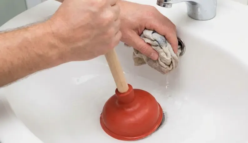 Uso correcto del desatascador de ventosa tapando el rebosadero